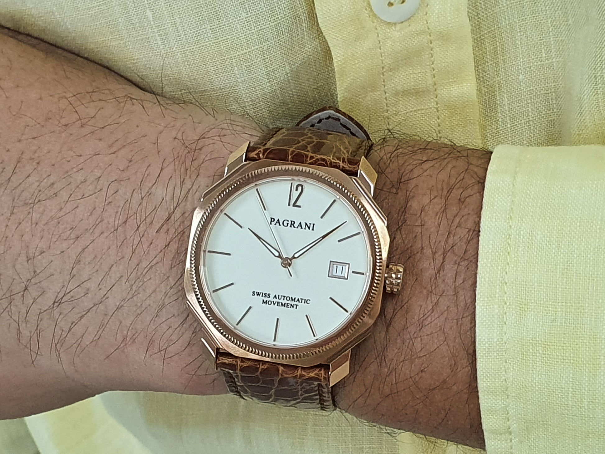 A Pagani brand watch with a white dial, rose gold case and bracelet, and a crocodile-textured brown leather strap.